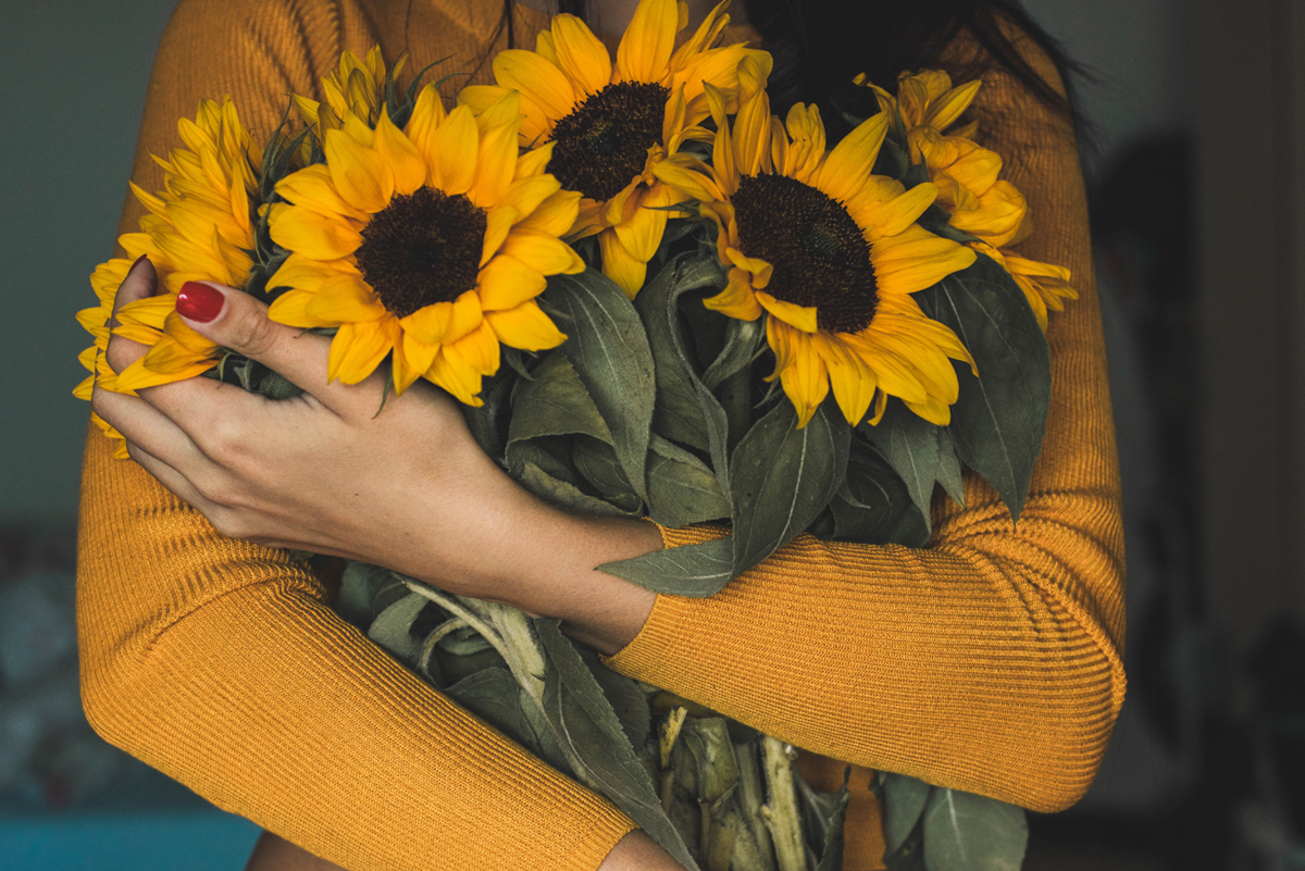 Woman Holding Sunflowers